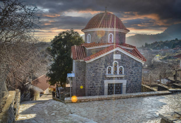 Beautiful stone Orthodox church in Valtesiniko village under an autumn dramatic sky, Arkadia, Greece Beautiful stone Orthodox church in Valtesiniko village under an autumn dramatic sky, Arcadia, Greece arachova greece stock pictures, royalty-free photos & images