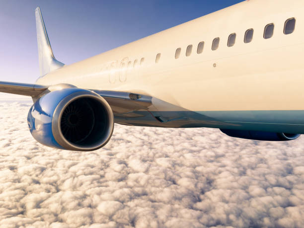 istock Passengers commercial airplane flying above clouds in sunset light. Flying above clouds in dramatic sun light. Airplane in the sky. Detail of commercial jet airplane flying above clouds 2176878705