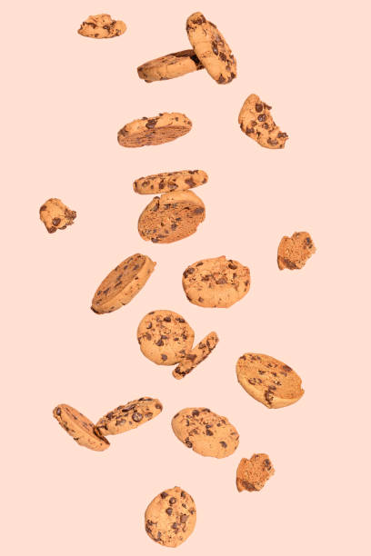 istock Chocolate cookies levitate on a light orange background. 2176878965