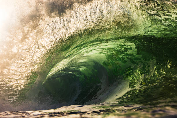 istock Wave breaking in the ocean with dramatic golden light at sunrise 2176880726