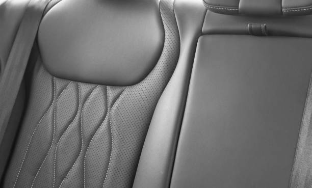 istock Back passenger black seats in modern luxury car. Black perforated leather with white stitching. Car details. Leather comfortable seats. Car interior details 2176882110