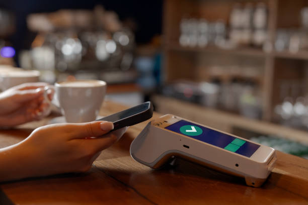 istock customer makes contactless NFC payment by phone through terminal in cafe, concept successful payment 2176883985