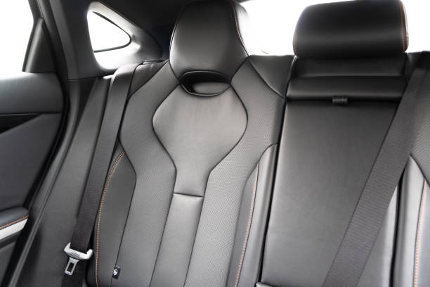 istock Back passenger black seats in modern luxury car. Black perforated leather with white stitching. Car details. Leather comfortable seats. Car interior details 2176886652