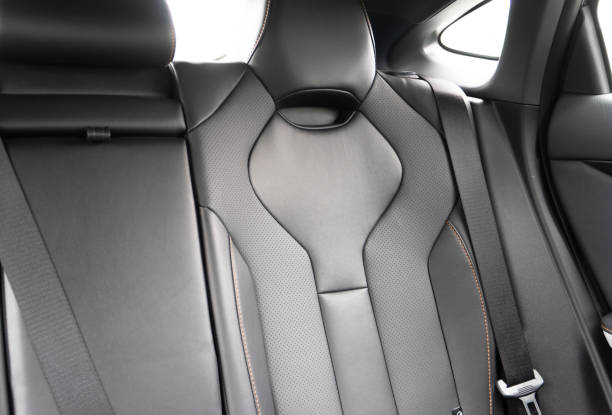 istock Back passenger black seats in modern luxury car. Black perforated leather with white stitching. Car details. Leather comfortable seats. Car interior details 2176887307
