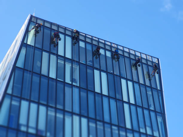 istock Skyscraper Soaring Squad: Rope Access Teamwork & Cooperation High Above the City and cleaning tower in nice weather. 2176890125