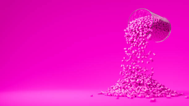 istock Pink plastic polypropylene granules pouring from the glass on a pink backdrop, masterbatch polymer grain pile. HDPE or PVC resin pellets. Place for text. 3d render illustration 2176890316