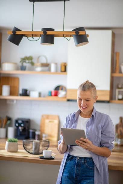 istock Woman using tablet in the morning in the kitchen 2176891092