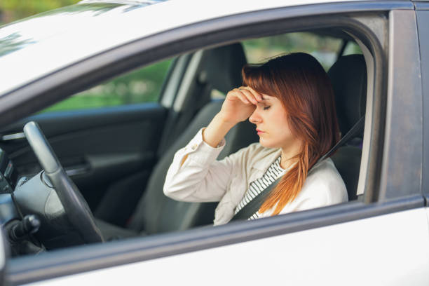istock stressed young woman driving in traffic 2176894273