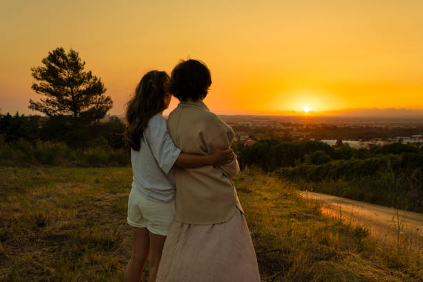 Mother and daughter watching the sunset