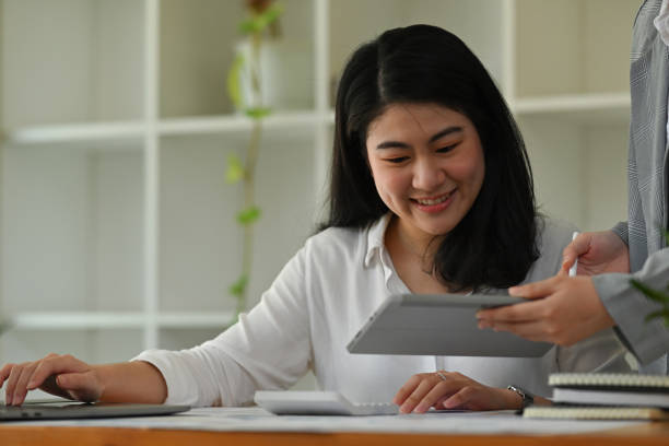 istock Portrait image of office worker and leader or coworker analyzing financial data on tablet together, business data analysis concept. 2176897124