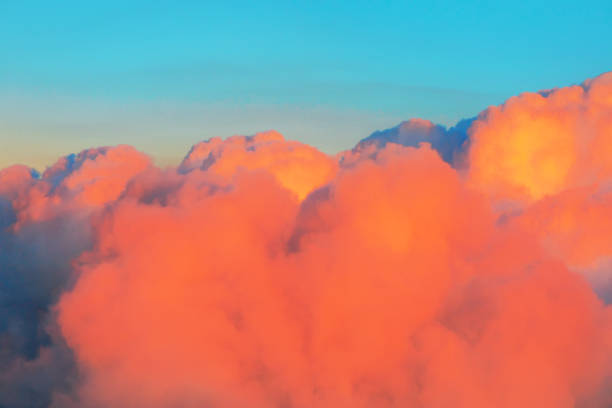 Flying Over Colorful Clouds in Blue Sky. Sunset Clouds High In The Sky