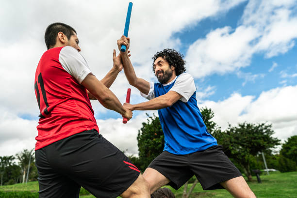 istock Male friends practicing escrima in a public park 2176903678