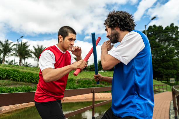 istock Male friends practicing escrima in a public park 2176903698