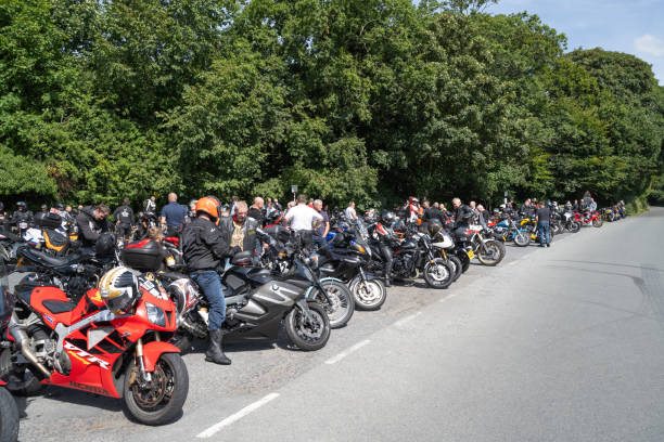 11.08.2024 Kirkby, UK. Motorcyclists gather near Devil’s Bridge in Kirkby Lonsdale, Carnforth. The scene shows a popular stop for riders, with rows of motorcycles lined up along the road, creating a lively atmosphere of camaraderie and adventure.