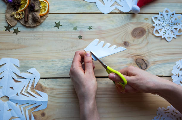 istock A snowflake made from paper with your own hands gracefully decorates a winter interior, adding warmth and a cozy atmosphere 2176907774