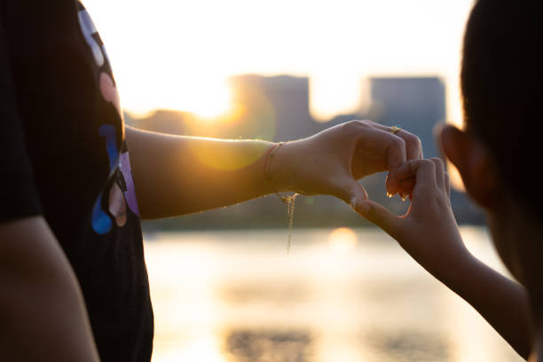 Mother with son using arms to make a heart