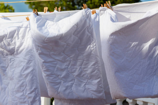 istock Murcia, Spain - 12th August 2024 - White laundry drying in sunlight against a clear blue sky, creating a vibrant atmosphere during a summer day 2176913498