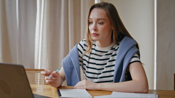 istock Serious woman planning project writing in notebook at home workplace closeup. 2176921610