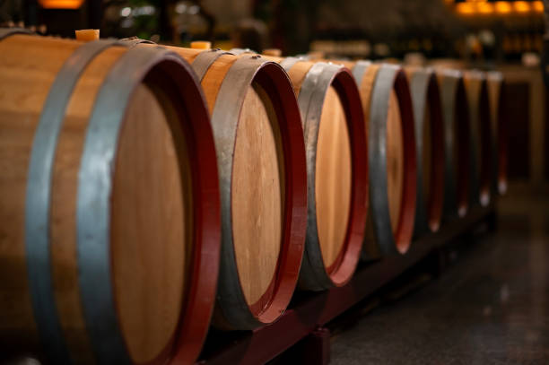 istock Old wooden wine barrels stacked in a cellar in order 2176933519
