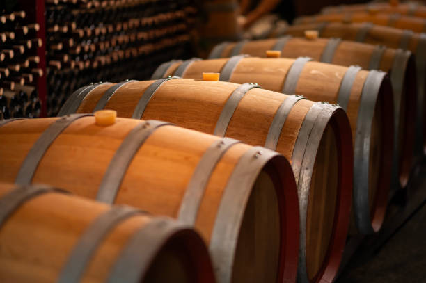 istock Old wooden wine barrels stacked in a cellar in order 2176933523