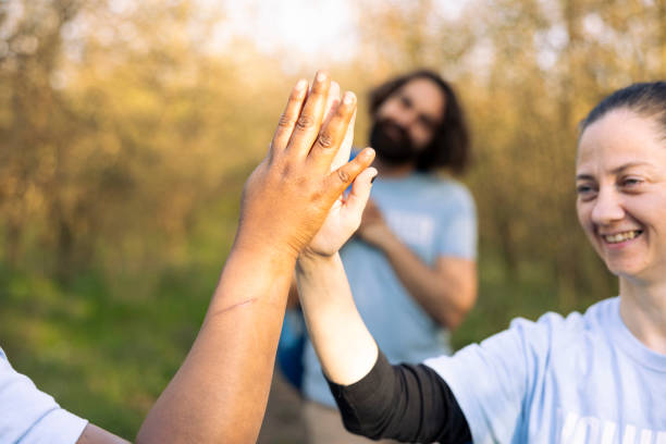 istock Happy team of environmentalists share high five with each other 2176936791