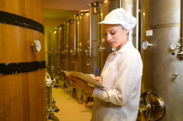 istock Professional winemaker controlling wine making process and quality at winery factory 2176937737