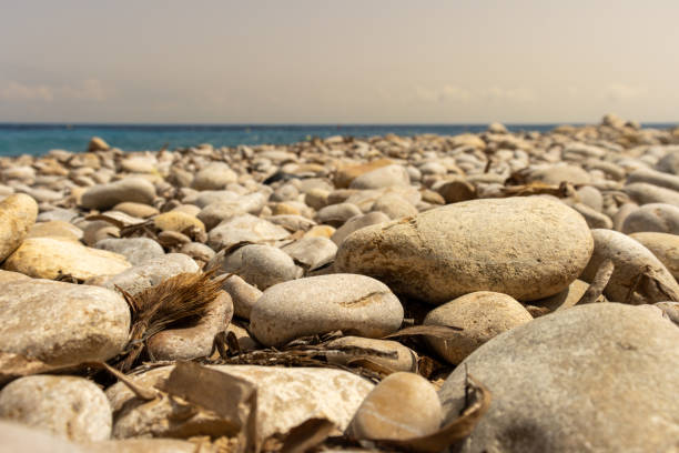 istock Pebble Beach Background with Calm Sea and Clear Sky 2176938592