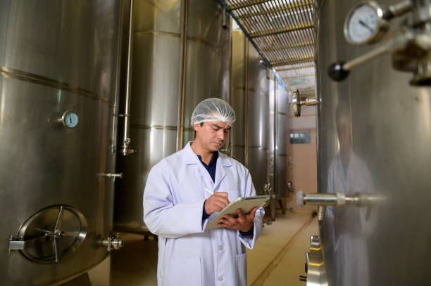 istock Professional winemaker controlling wine making process and quality at winery factory 2176938654