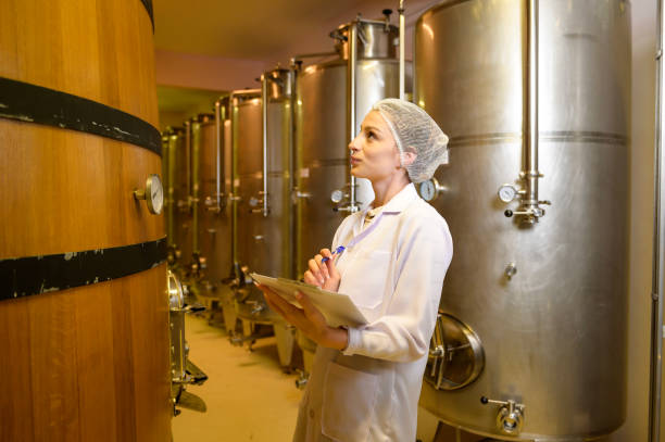 istock Professional winemaker controlling wine making process and quality at winery factory 2176938683