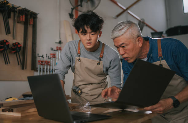 istock Asian Chinese senior carpenter and apprentice disucssion in woodwork workshop 2176939823
