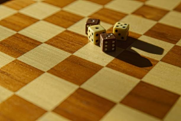 istock Stack of dices on brown wooden board background 2176943814