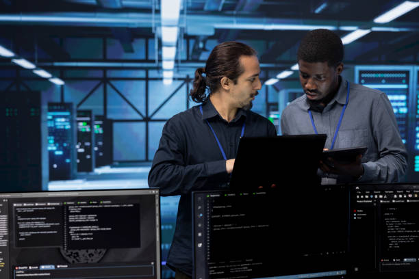 istock Coworkers in data center workspace checking recovery plan 2176951484