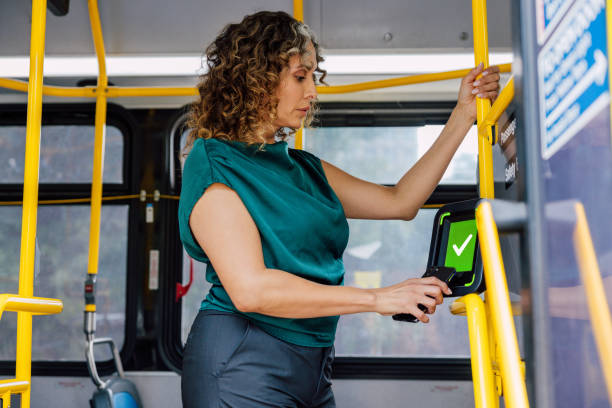 istock Woman tapping to pay bus ride 2176951957