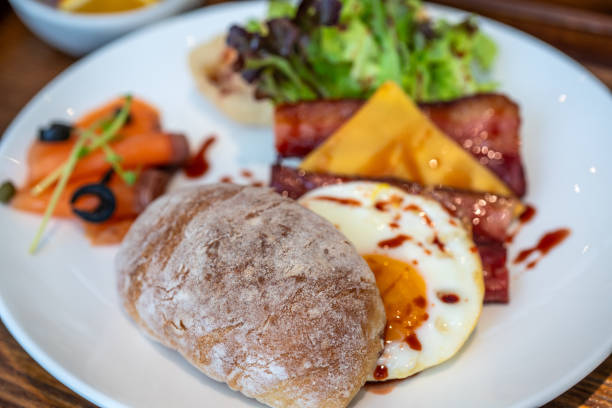 Western brunch - smoked salmon, fried eggs, toast, bacon, cheese, lettuce.
