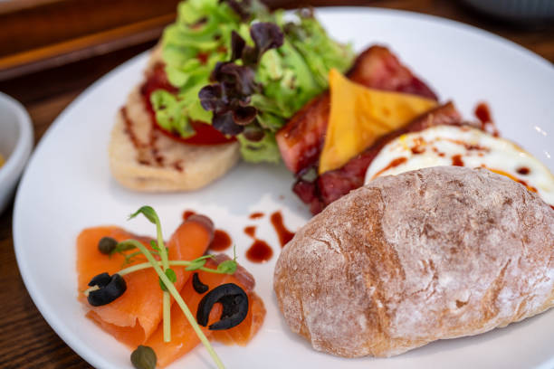 Western brunch - smoked salmon, fried eggs, toast, bacon, cheese, lettuce.