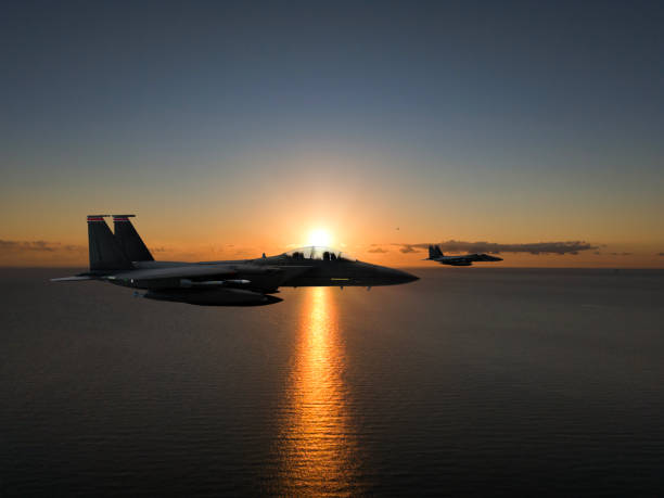 istock F-15 Eagle flying over sea at sunset. 2176955693