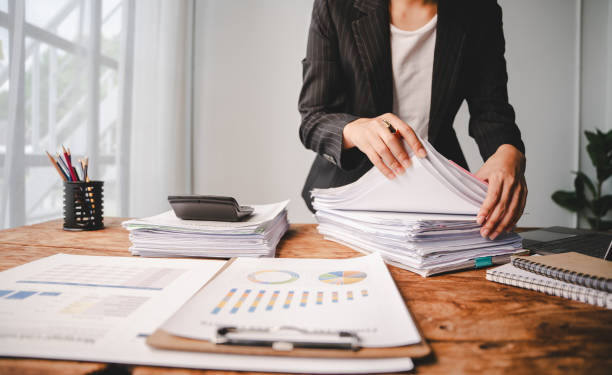 istock Employees who work with a lot of documents Searching for documents Accounting for income, expenses, tax records, and hard work 2176958062