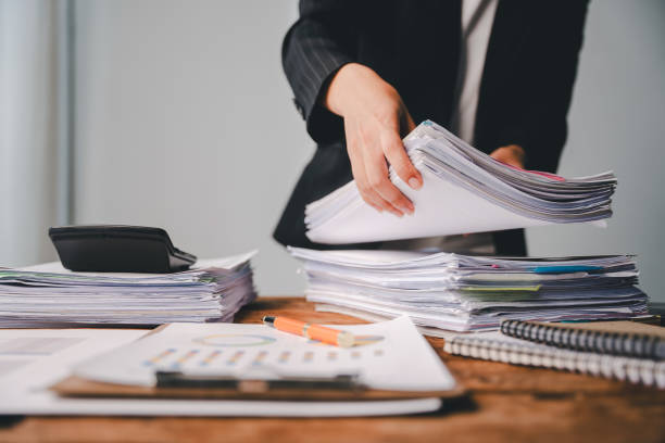 istock Employees who work with a lot of documents Searching for documents Accounting for income, expenses, tax records, and hard work 2176958067