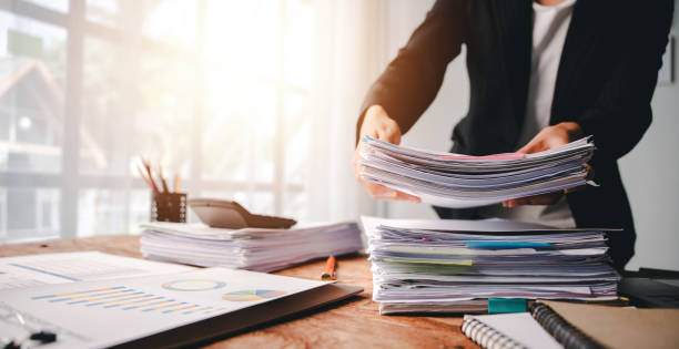 istock Employees who work with a lot of documents Searching for documents Accounting for income, expenses, tax records, and hard work 2176958081