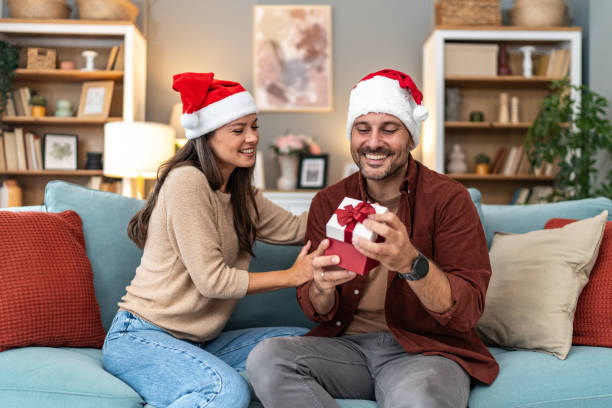 istock Wife surprising husband with Christmas present 2176958234