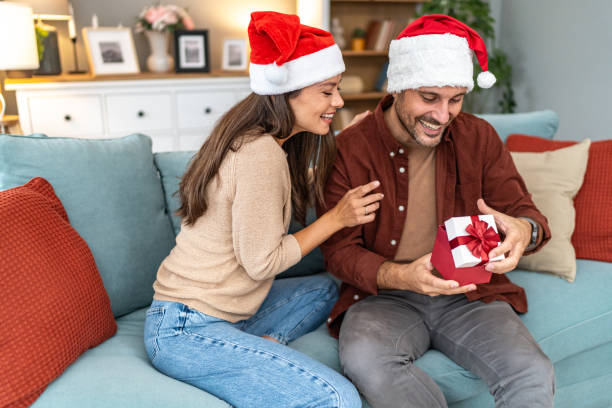 istock Wife surprising husband with Christmas present 2176958378