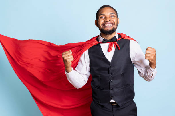 istock Confident bellboy with suit and tie wearing a red superhero cape 2176959594