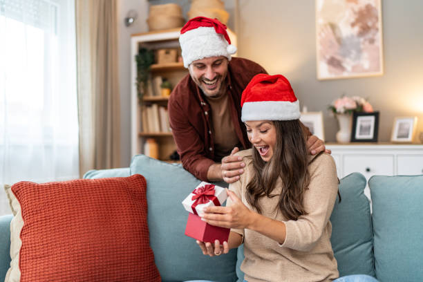istock Husband surprising wife with Christmas present 2176959732