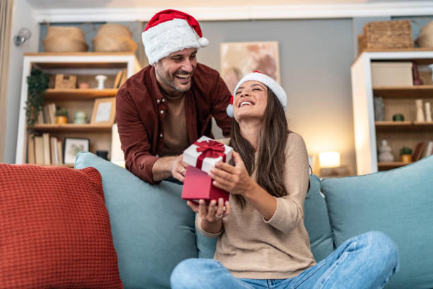 istock Husband surprising wife with Christmas present 2176960338