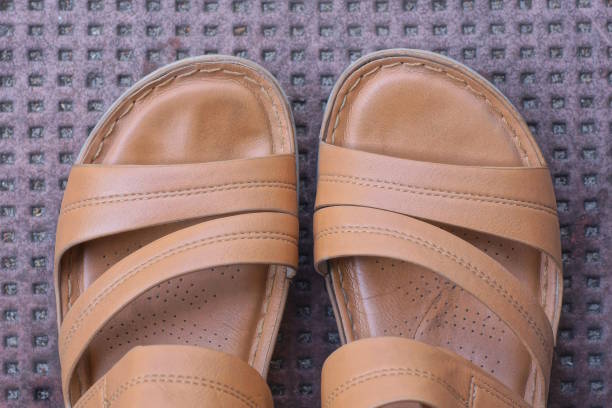istock leather brown summer sandals stand in floor 2176963875