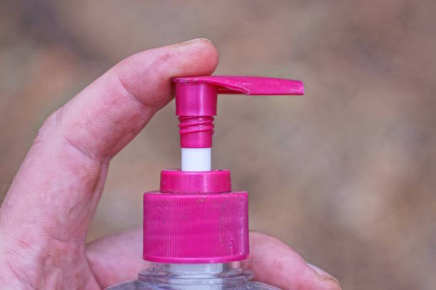 istock finger clicks on a red plastic dispenser in a bottle 2176964100