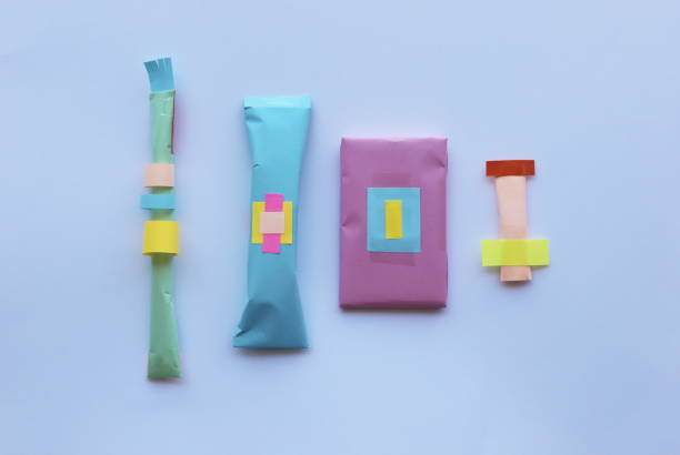 istock Four presents arranged in a row, isolated on bright background  - Top view photo. 2176970740