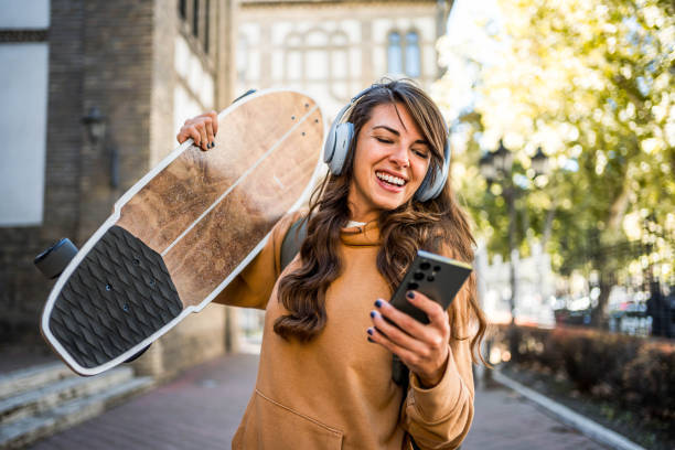 istock Young woman using a smartphone after skateboarding 2176972361