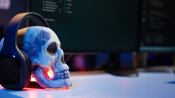 Extreme close up of software interface on PC screens showing lines of code running in empty criminals den. Hacking malware programming script on displays in underground base, handheld camera shot