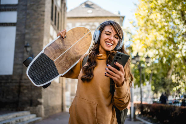 istock Skateboarder woman using her phone 2176973504